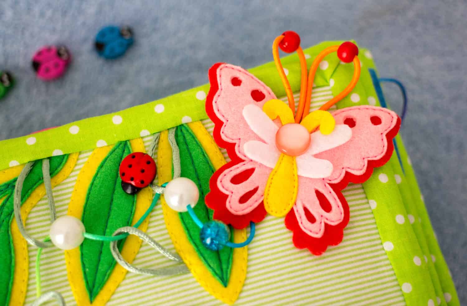 Butterfly. Handmade kids fabric textile cotton and felt quiet book. Fragment with handwork  elements.