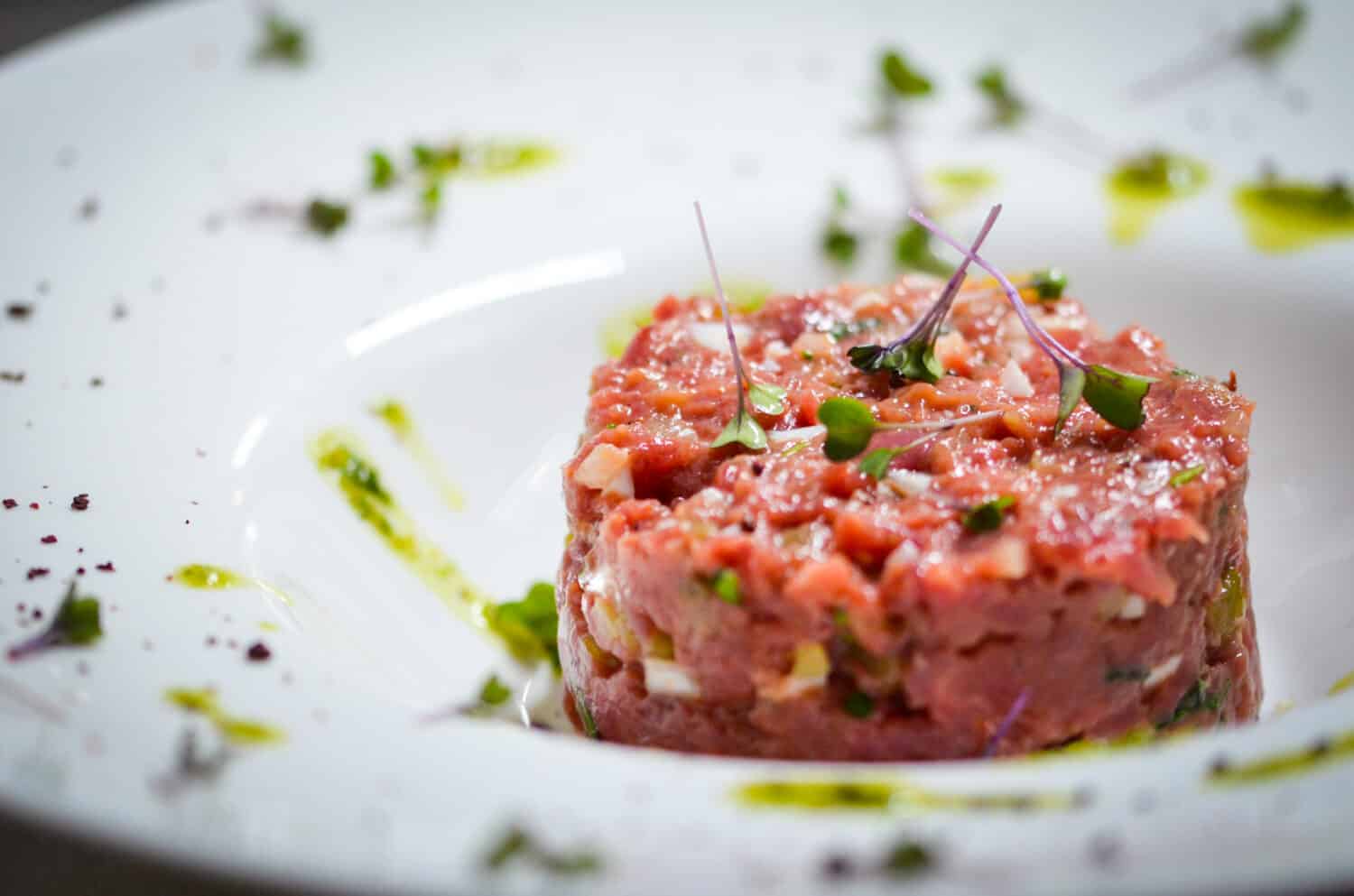 fresh beef tartar dish with tasty vegetables