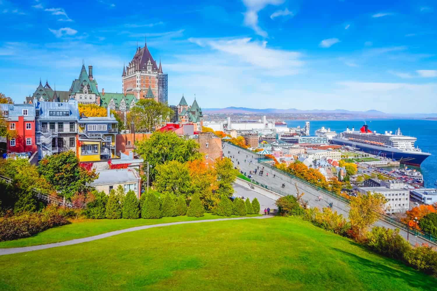 Skyline view of Old Quebec City with iconic Chateau Frontenac and Dufferin Terrace against St. Lawrence river in autumn sunny day, a national historic site of Canada, most famous landmark of Quebec.