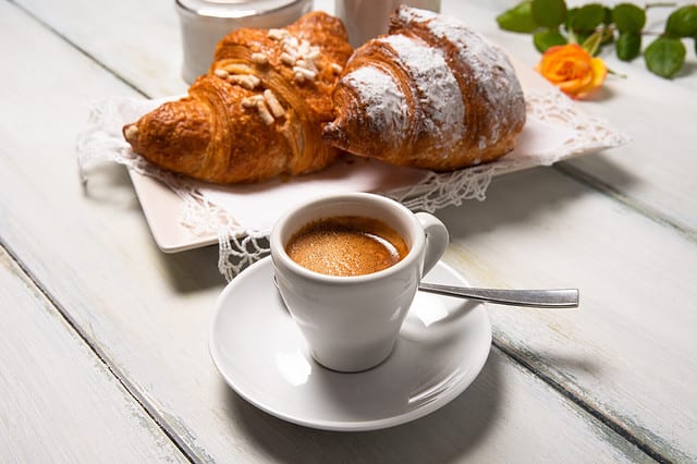 Cup of italian espresso and brioches