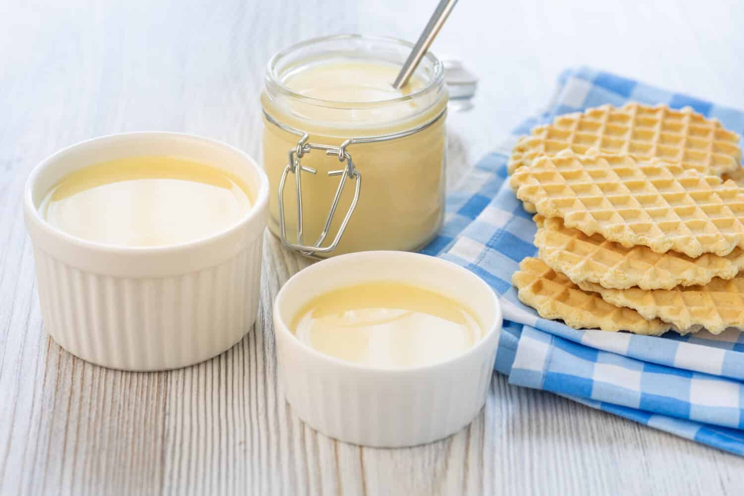 Sweet Condensed or evaporated milk and waffles on a table. A delicious Breakfast.