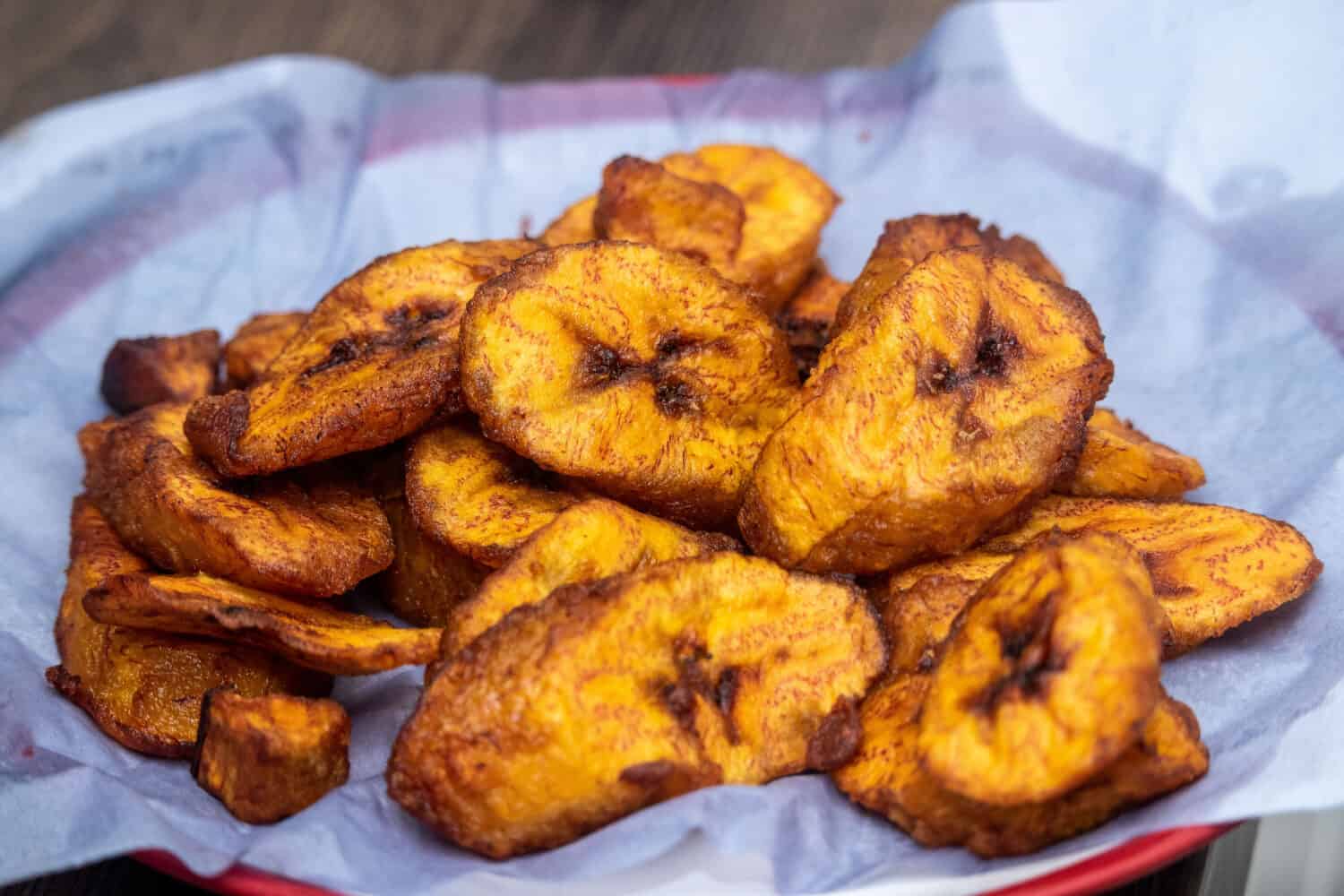 Ripe fried African plantain - local staple food served as meals with sauce or as a side dish in Nigeria, West Africa and other African countries. Deep Fried Nigerian Plantains ready to be served.