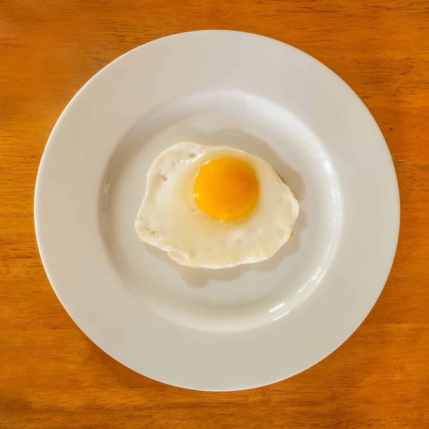 Sunny side up egg on a white plate