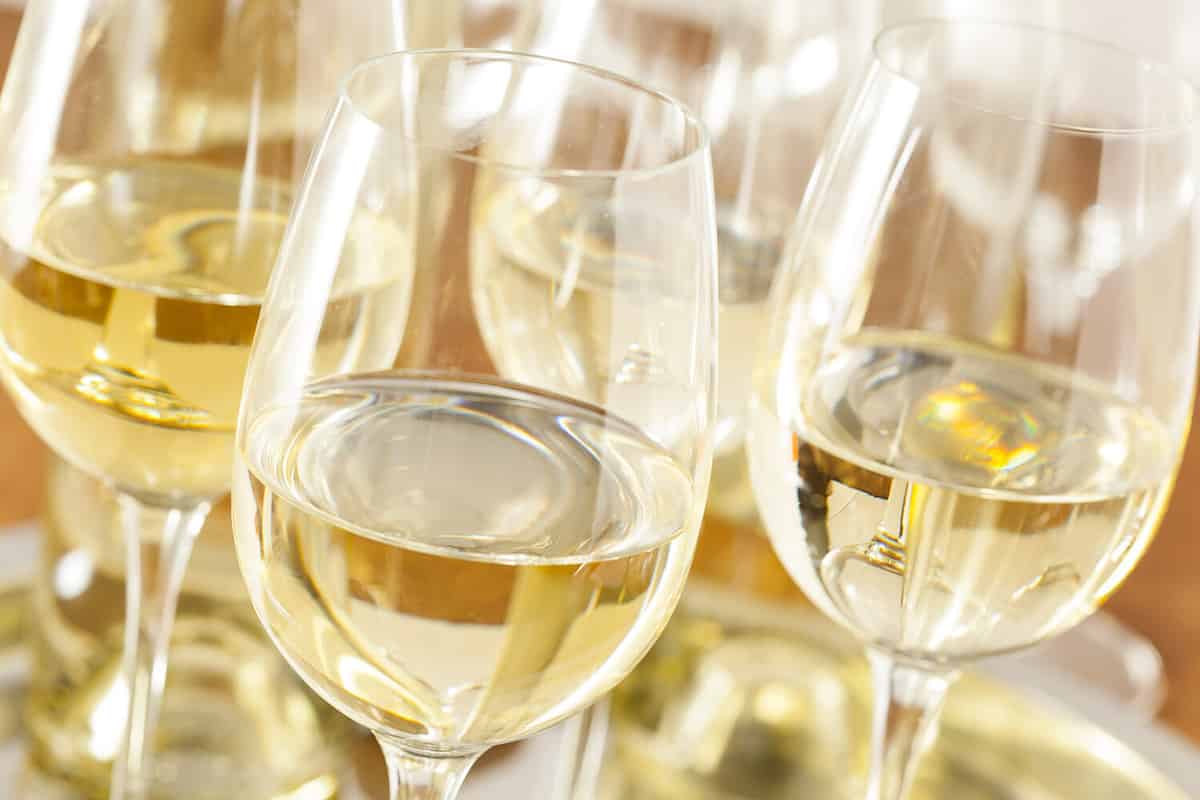 Refreshing White Wine in a Glass on a Background