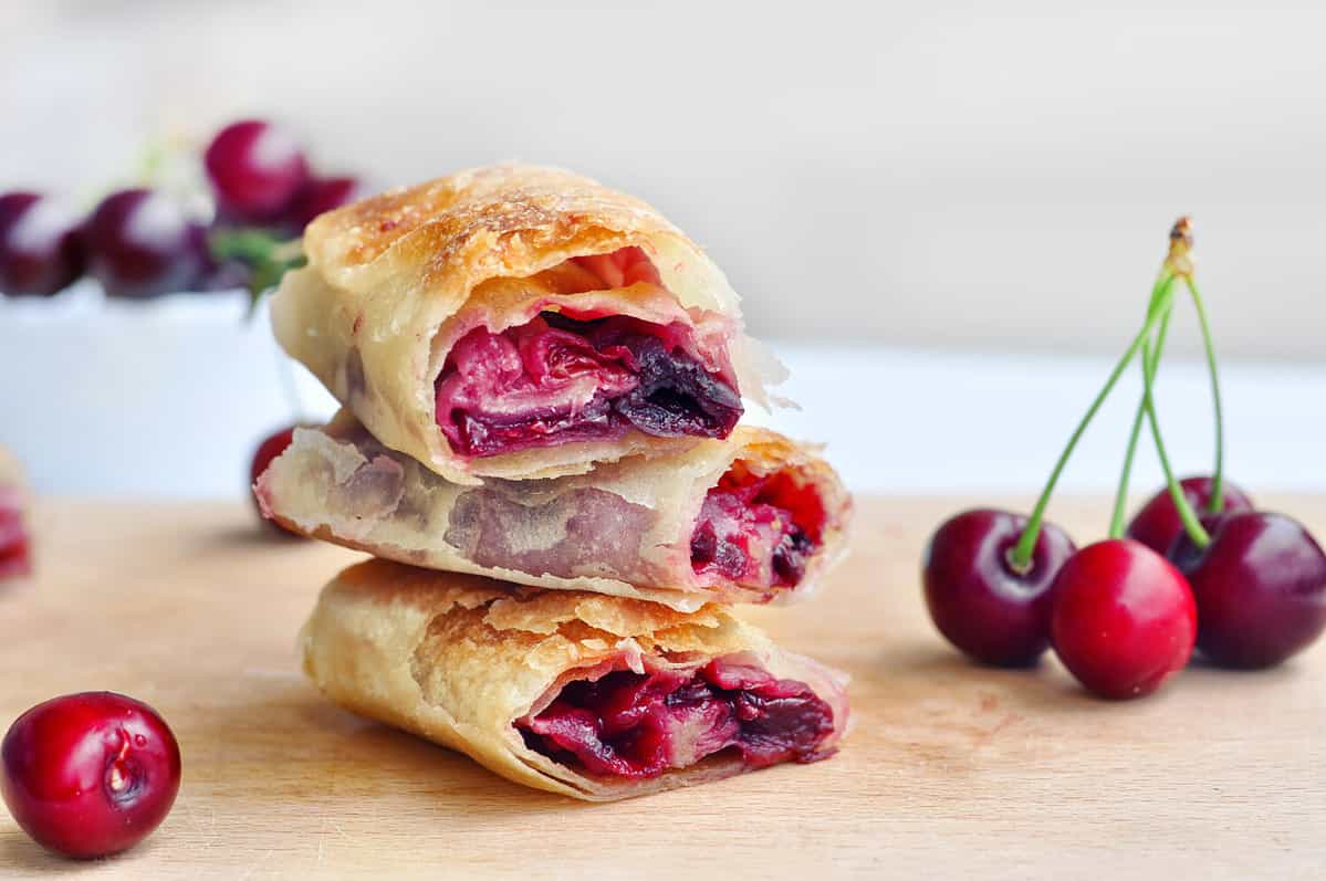 Delicious Homemade Cherry Pie.Sweet slices of cherry strudel on a wooden table. Traditional cuisine.