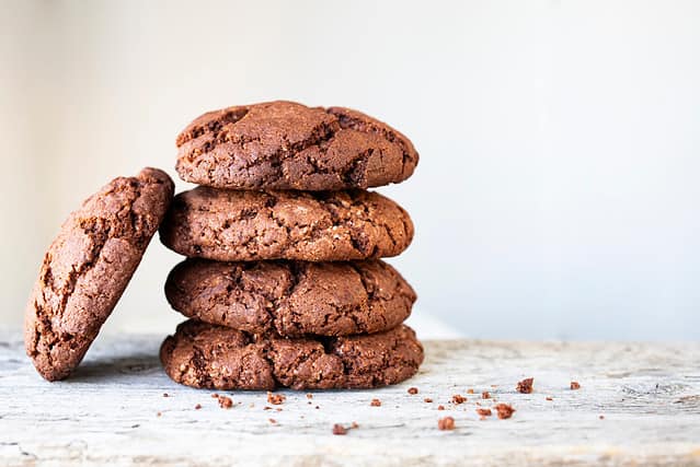 Fresh homemade chocolate chip cookies on a wooden background.