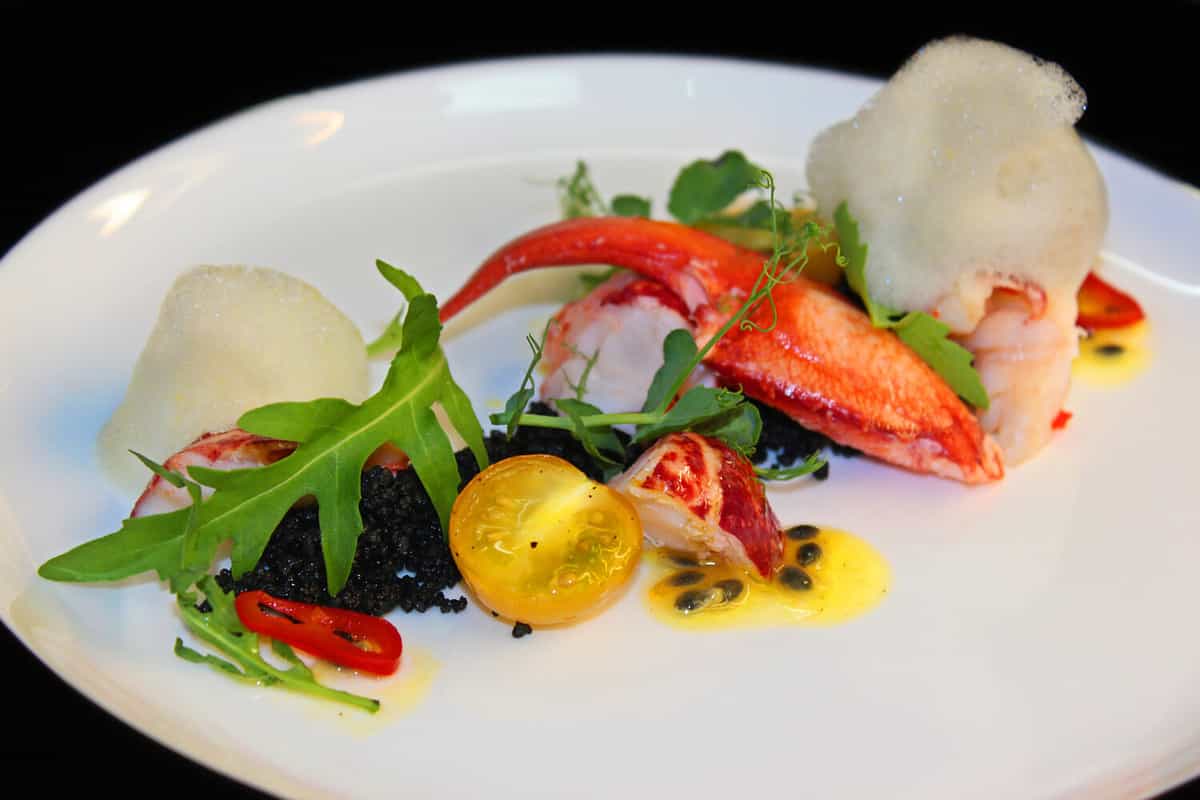 poached lobster salad with cherry tomatoes and green leaves