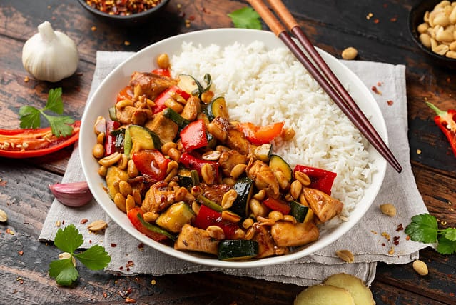 Kung Pao Chicken with Peppers, zucchini and rice. Asian take away food