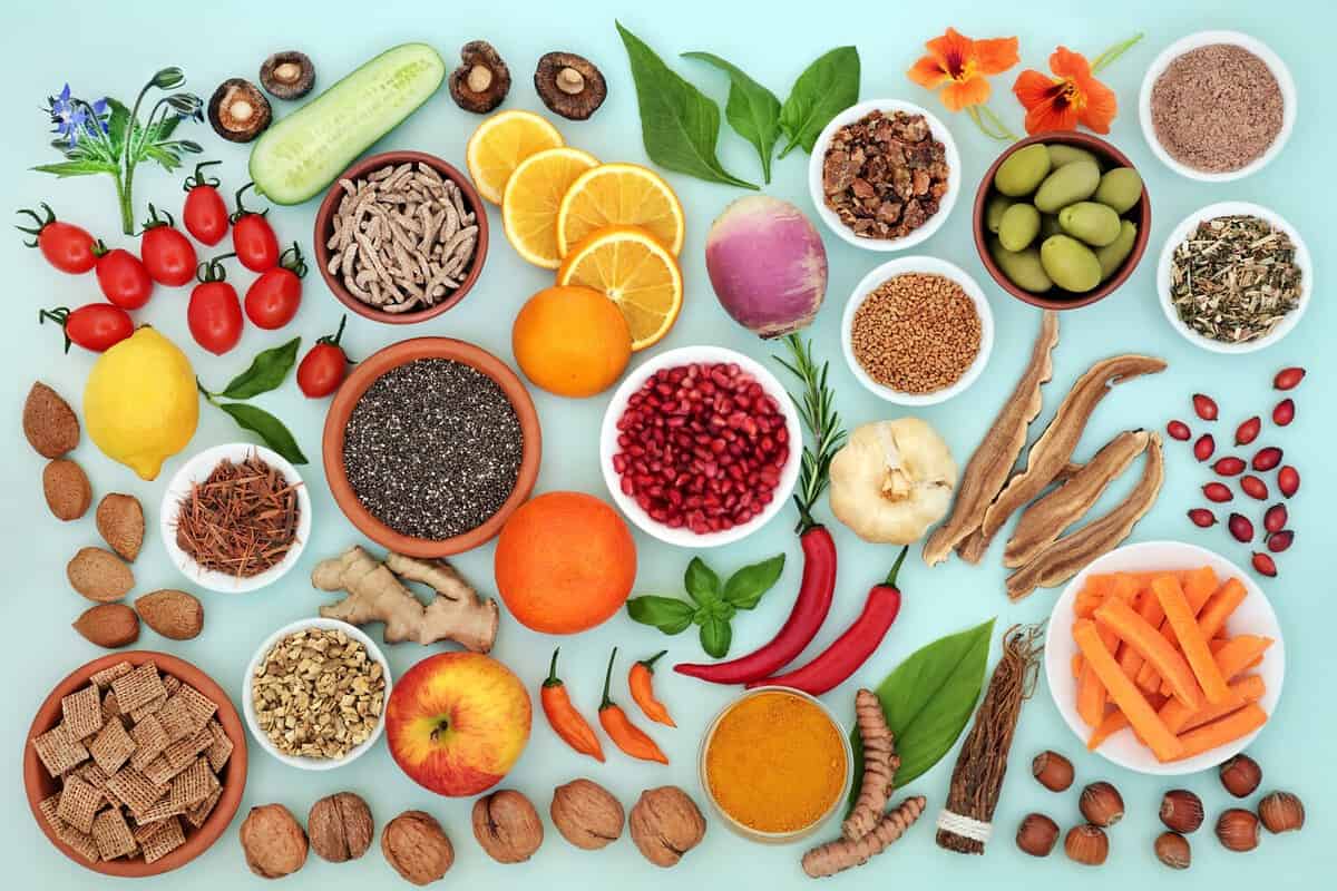 Vegetarian and vegan immune boosting foods for fitness. Vegetables, fruit, medicinal herbs and spice. Health food high in protein, omega 3, antioxidants, anthocayanin, lycopene, fibre, vitamins.