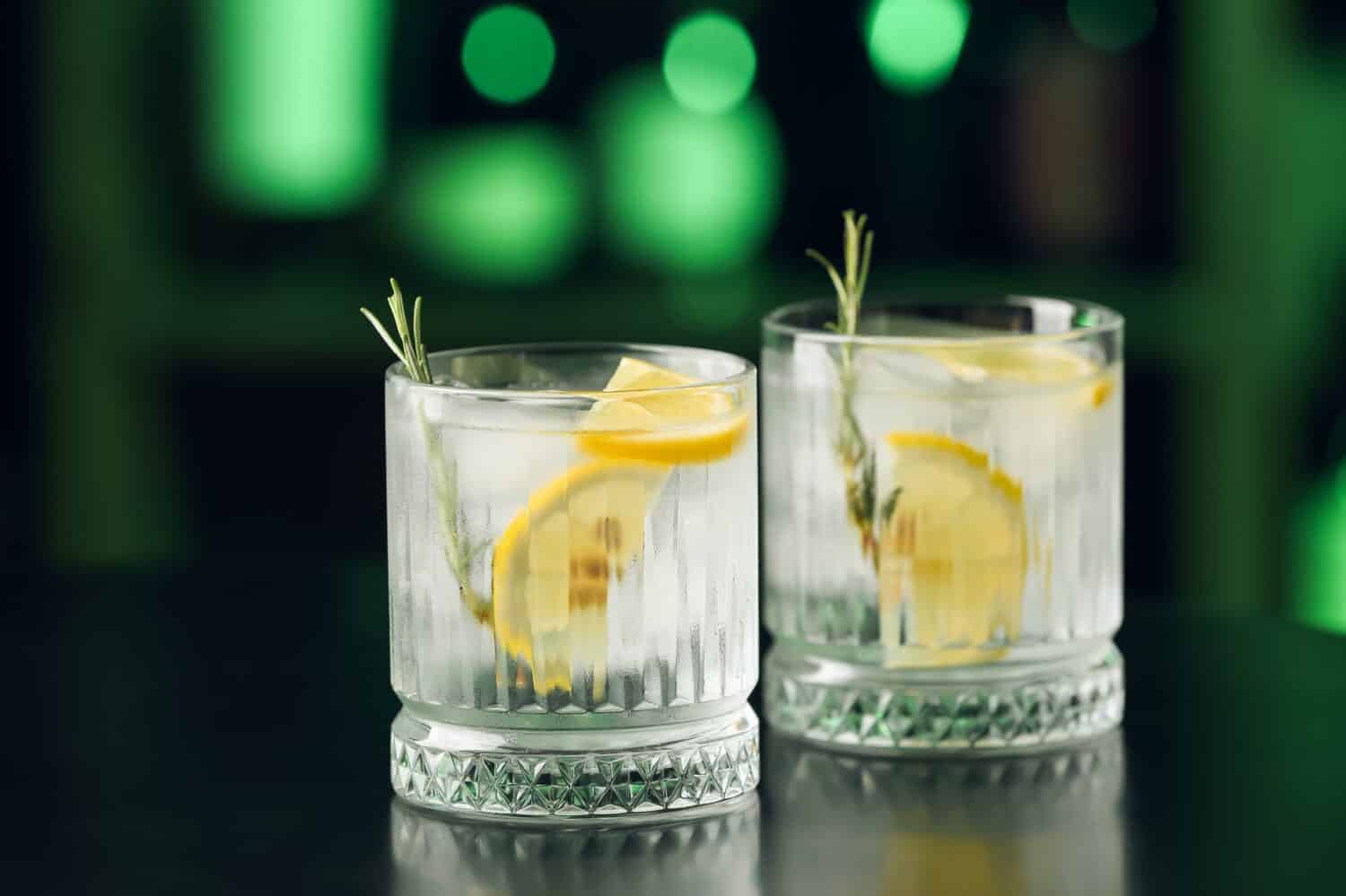 Glasses of cold gin tonic on table in bar