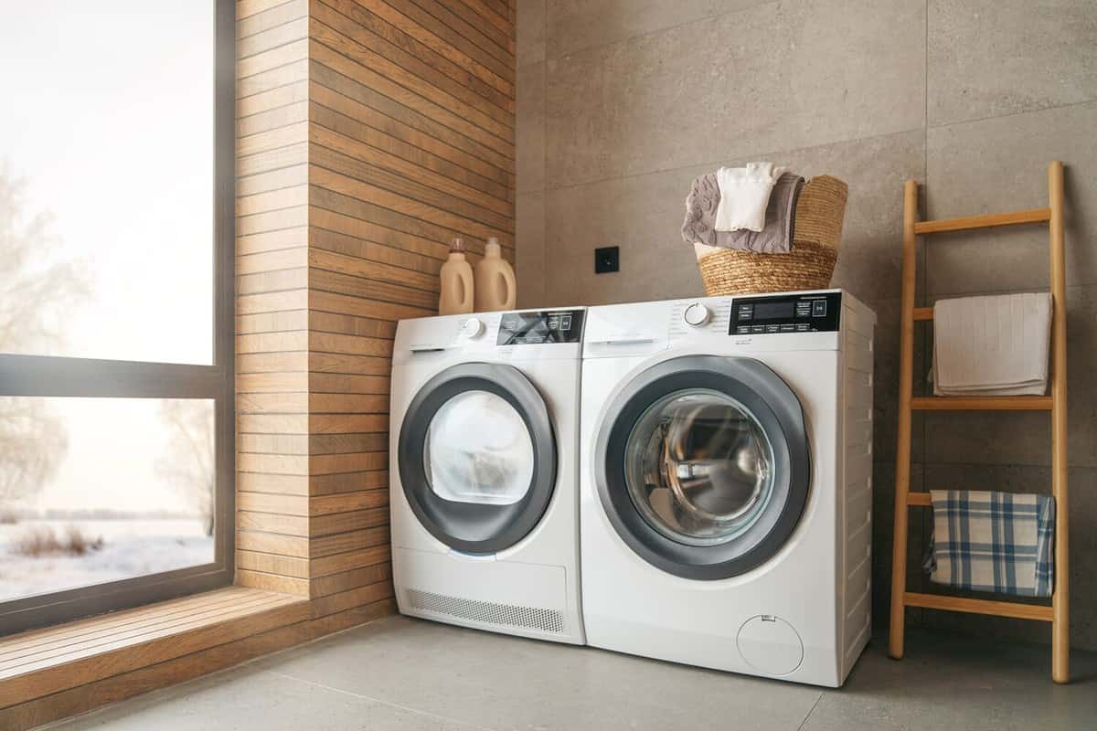 Interior of a real laundry room with a washing machine at home