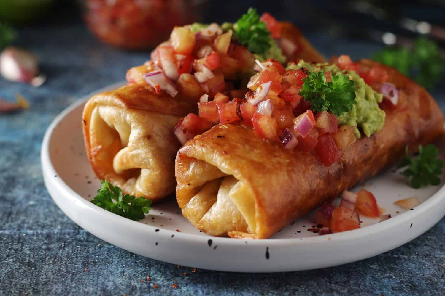 A typical dish of Mexican cuisine - Chimichanga, made of tortilla with different ingredients	