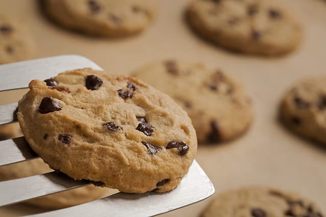 Homemade chocolate chip cookies served with a spatula