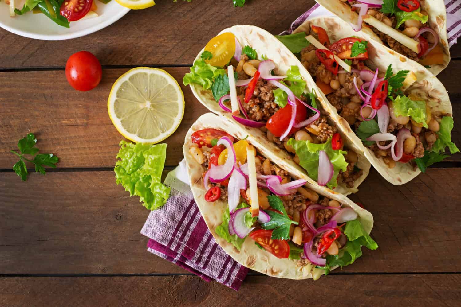 Mexican tacos with meat, beans and salsa. Top view