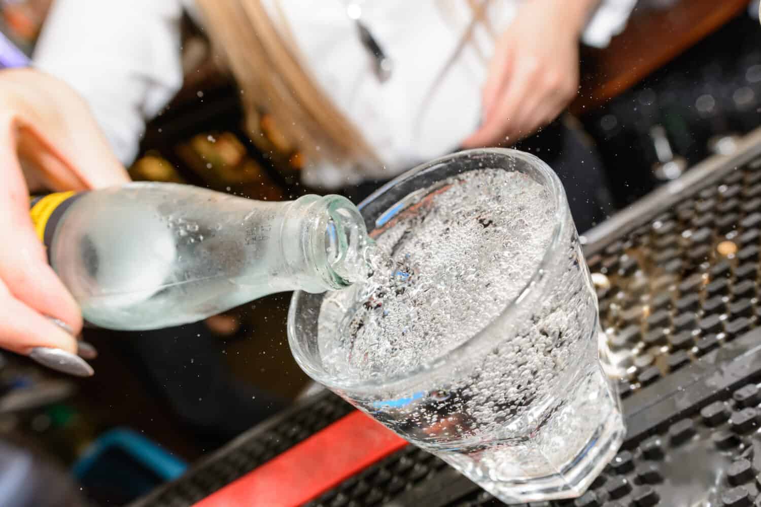 soda being poured into glass 