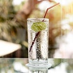 Glass of fresh sparkling mineral water and a lime in blur blackground