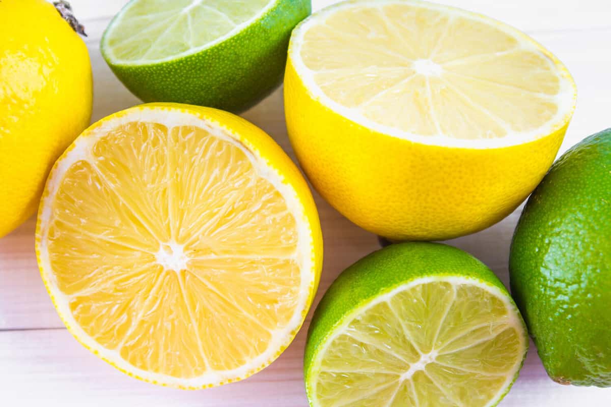 lemons and limes on a wooden background.