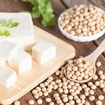 Tofu with soy bean on wooden board.