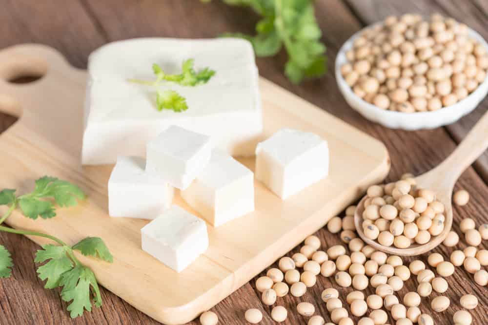 Tofu with soy bean on wooden board.