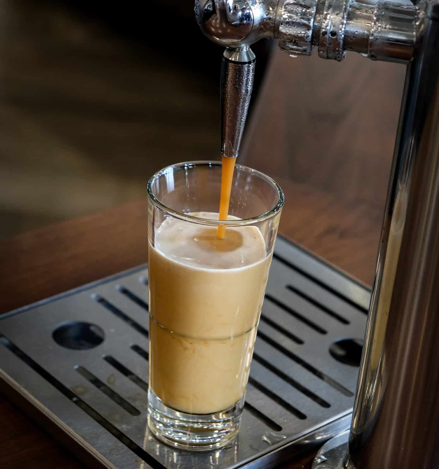 Frothy fresh nitro coffee from the tap,barista make from roasted bean coffee