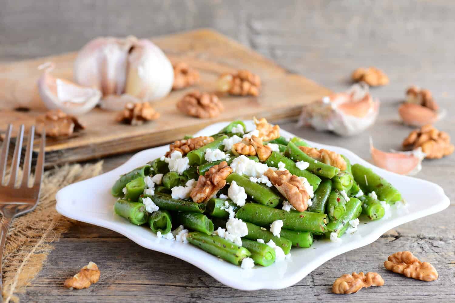 Warm green bean salad with cottage cheese and peeled walnuts. Diet green beans recipe. Vegetarian main dish. Rustic style