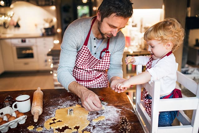 Young family making cookies at home.