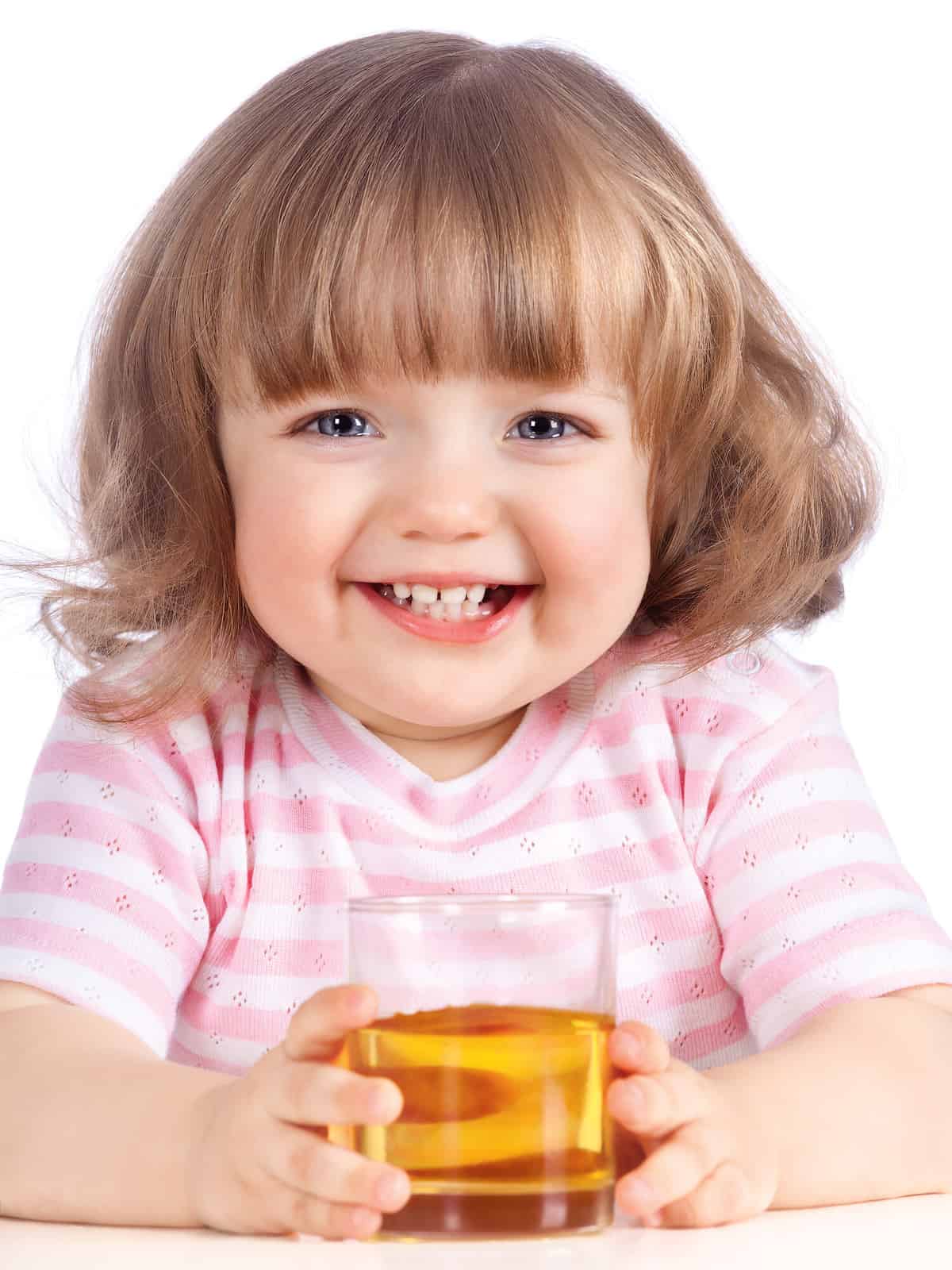 little girl drinking apple juice