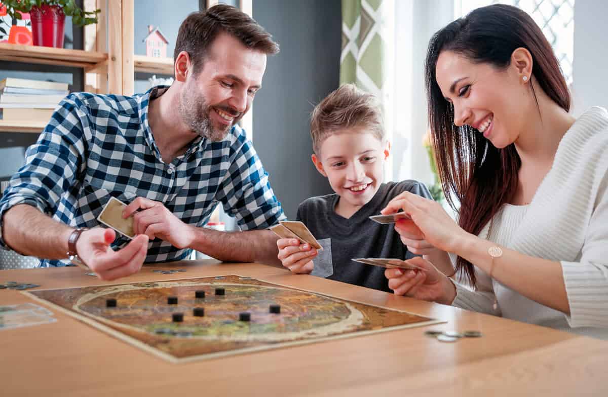 Happy family playing board game at home, happiness concept