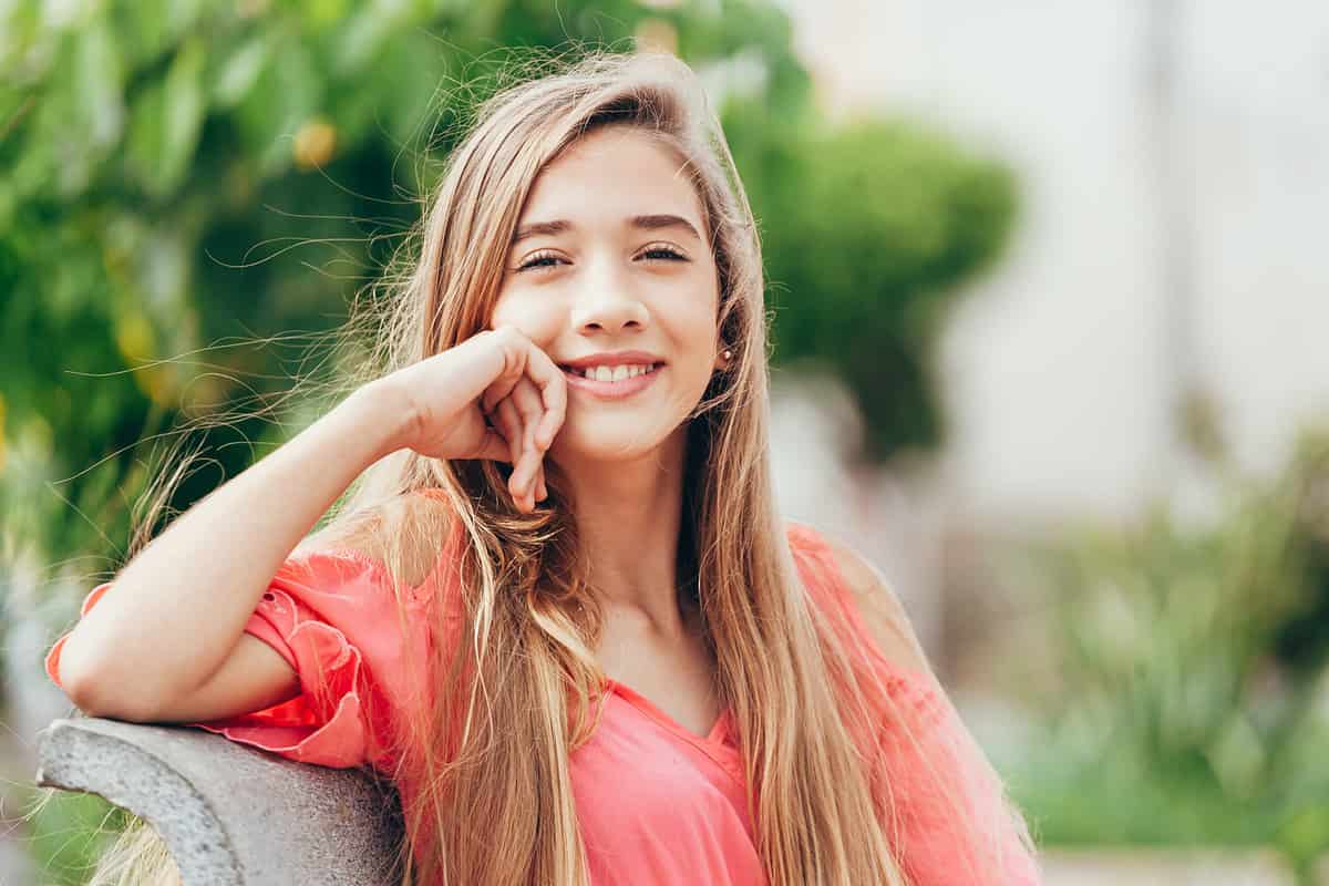 Outdoor portrait of 12 years old girl with long hair