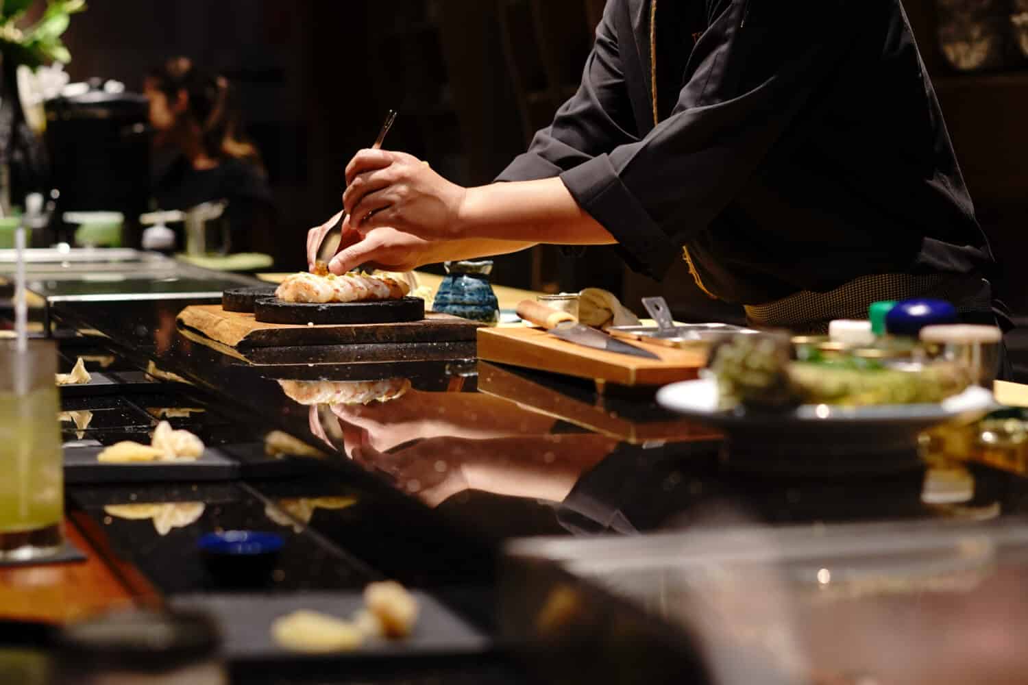 Japanese Chef making uni nigiri omakase style eating. Omakase style Japanese traditional.