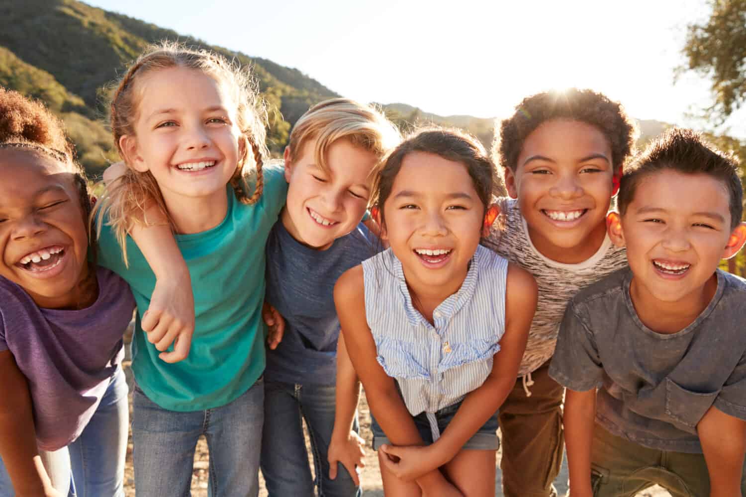 Portrait Of Multi-Cultural Children Hanging Out With Friends In The Countryside Together