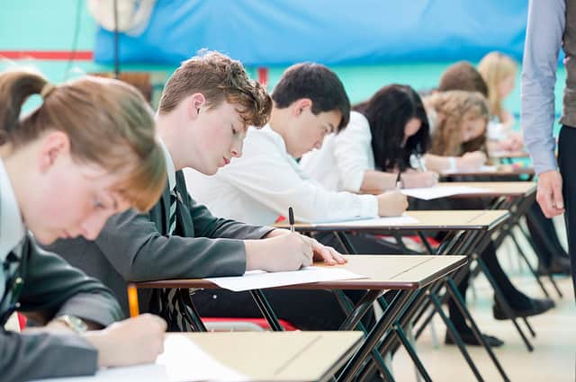 Close up of focused middle school students taking examination at desks