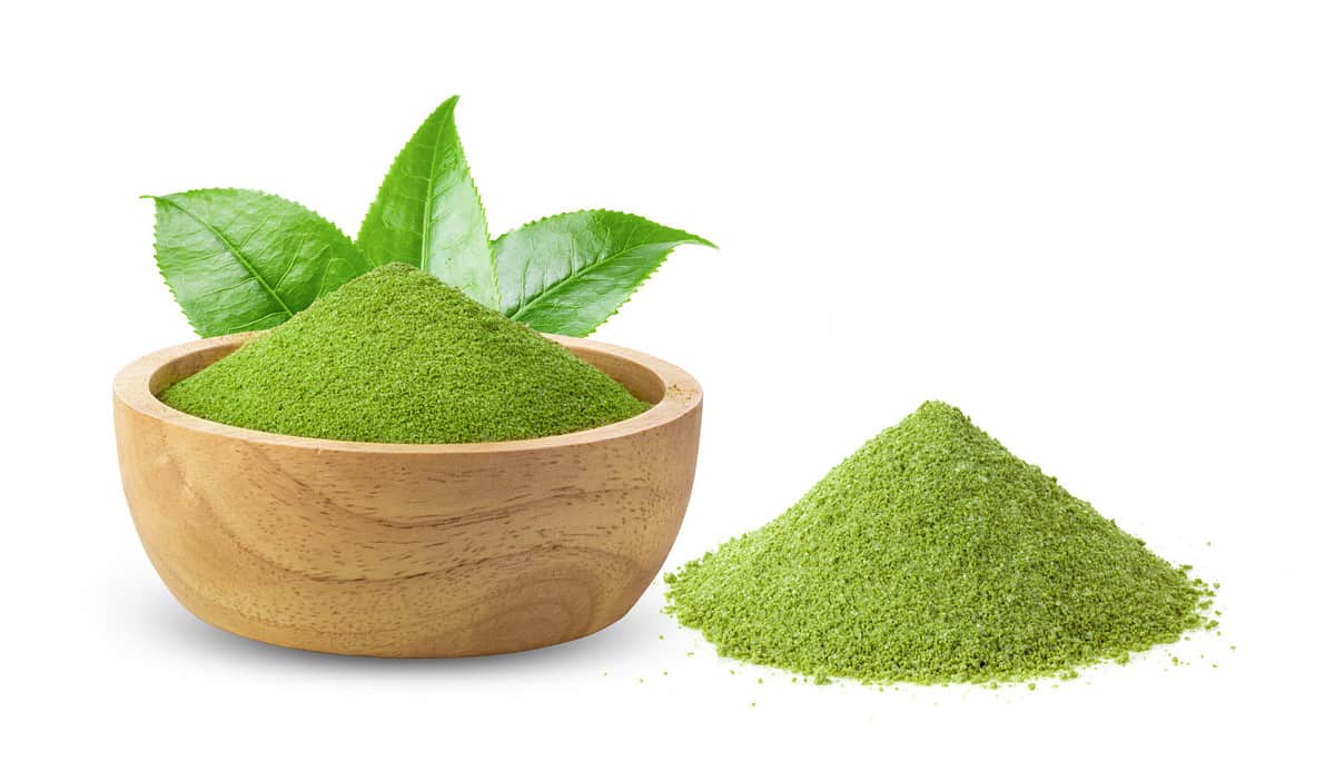 instant matcha green tea in wood bowl on white background