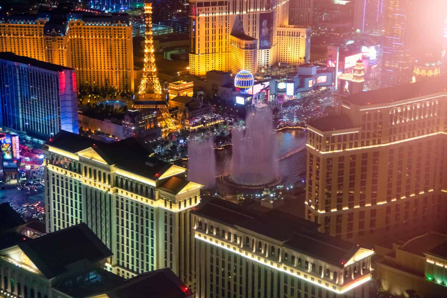 Night lights in The Strip, Las Vegas. Aerial view of most famous city casinos from helicopter, Nevada - USA