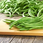 green beans handful on a cutting board, rustic style.