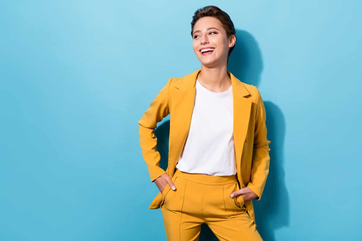 Photo portrait business woman wearing yellow blazer laughing looking copyspace isolated pastel blue color background