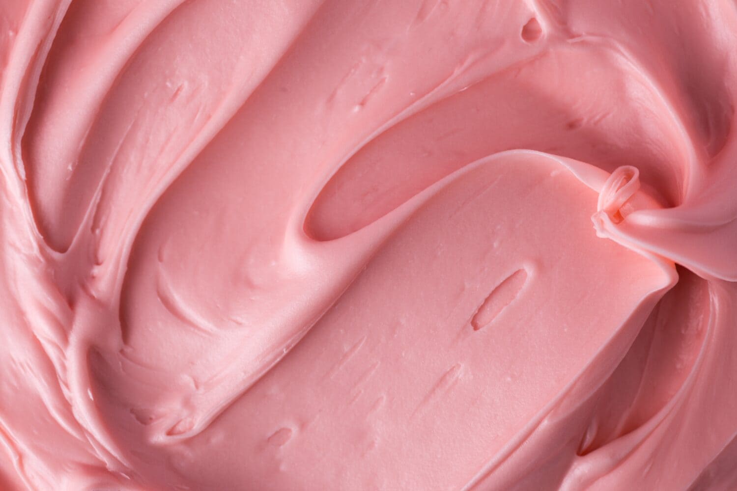 Pink icing frosting close up texture