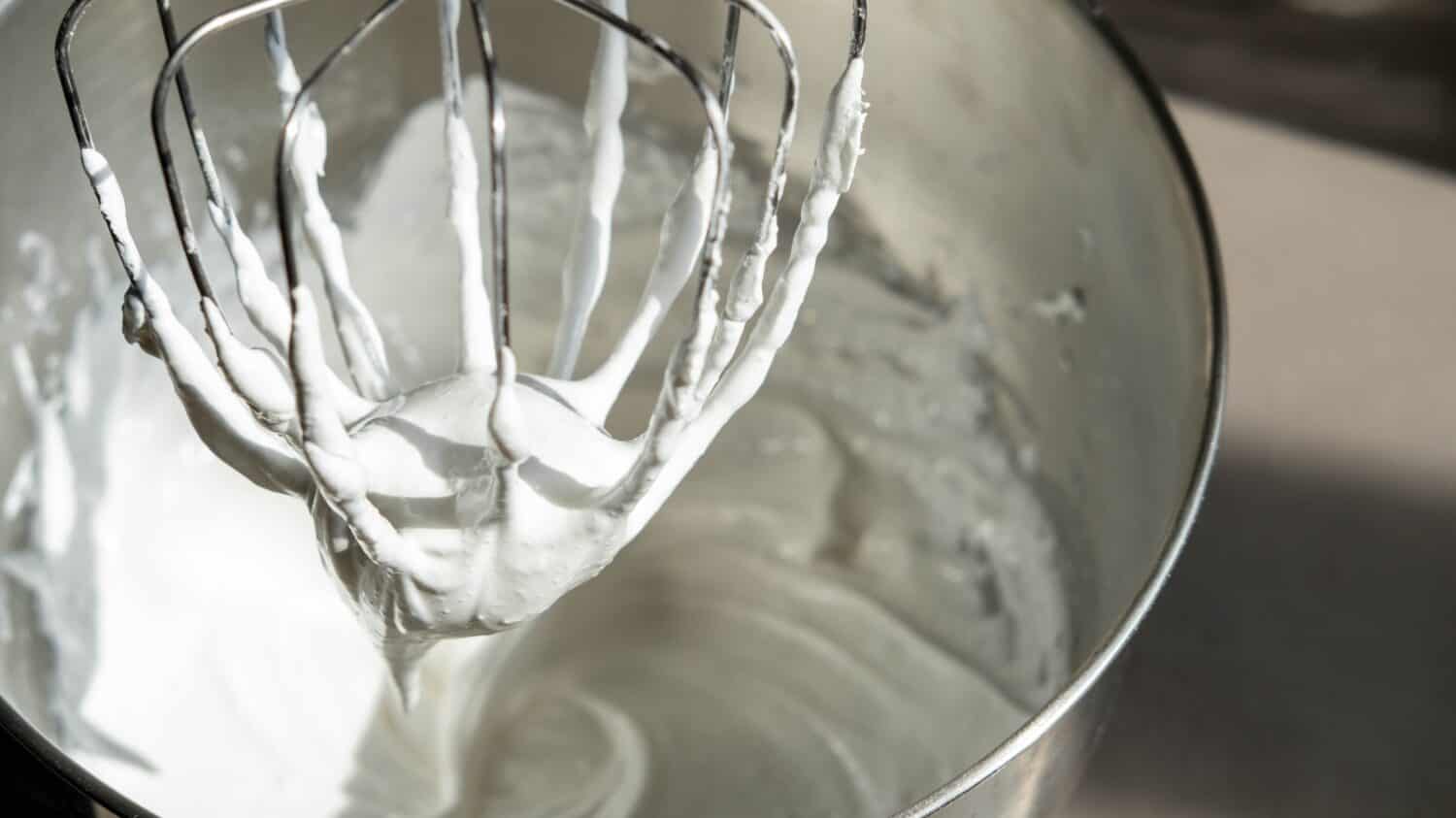 Mixing Whipped Cream in a Stand Mixer with a Whisk Attachment: Heavy whipping cream mixed with a stand mixer wire whisk