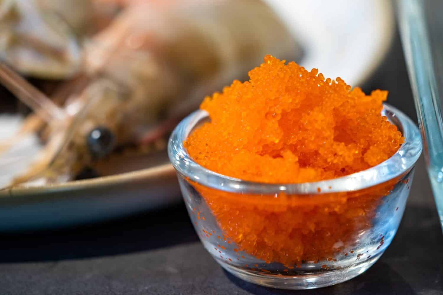 Focused on fresh Tobiko, flying fish roe with blur Shrimp beside it.