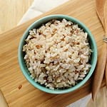 Organic Brown Rice in the bowl on the wooden table