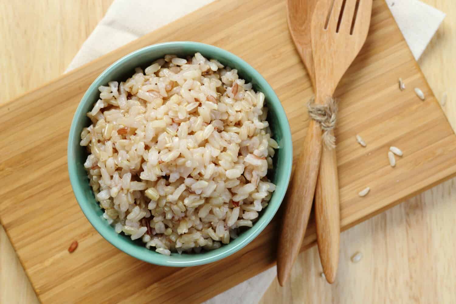 Organic Brown Rice in the bowl on the wooden table