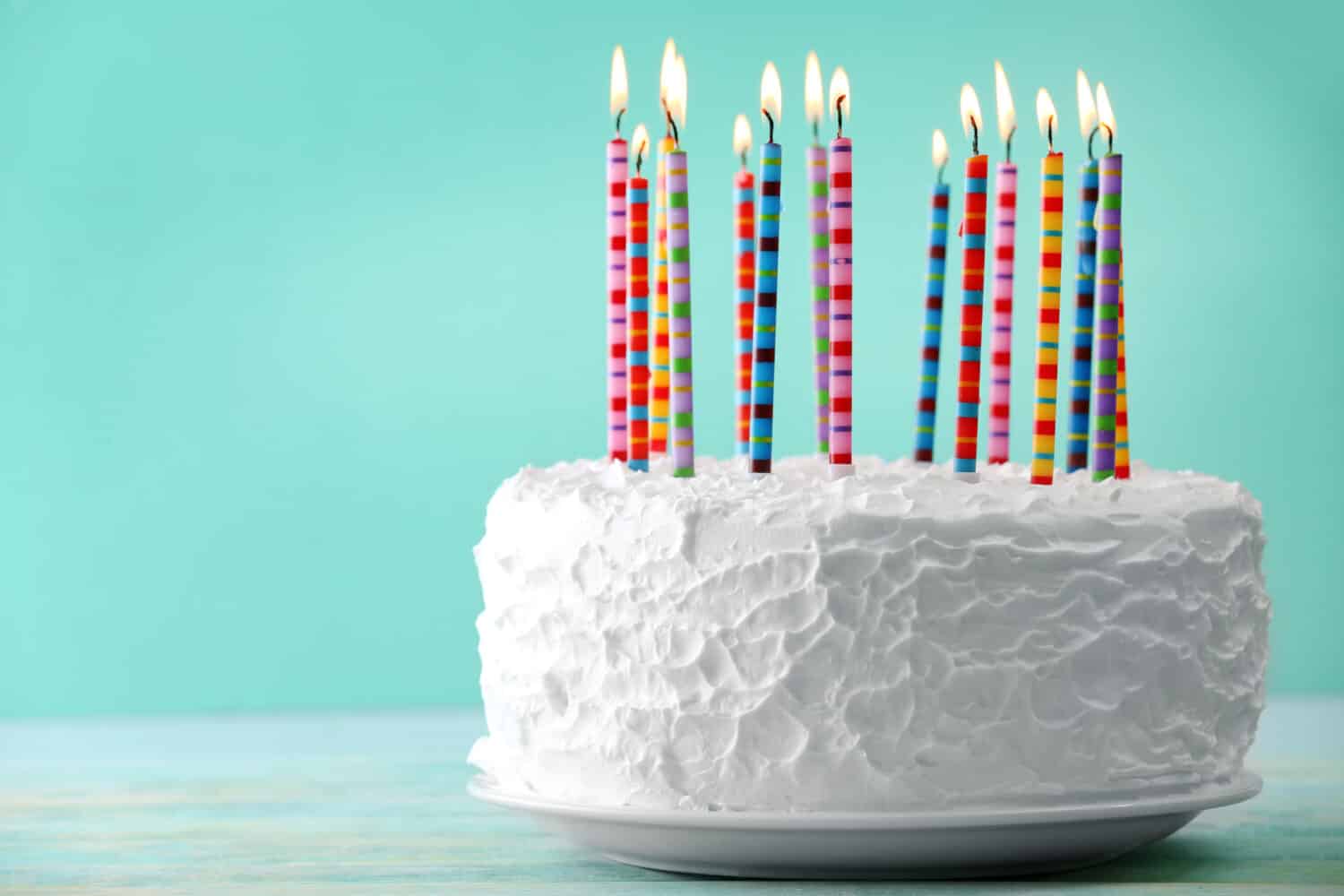 Birthday cake with candles on color background