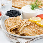 traditional Russian crepes with caviar and salted fish, horizontal