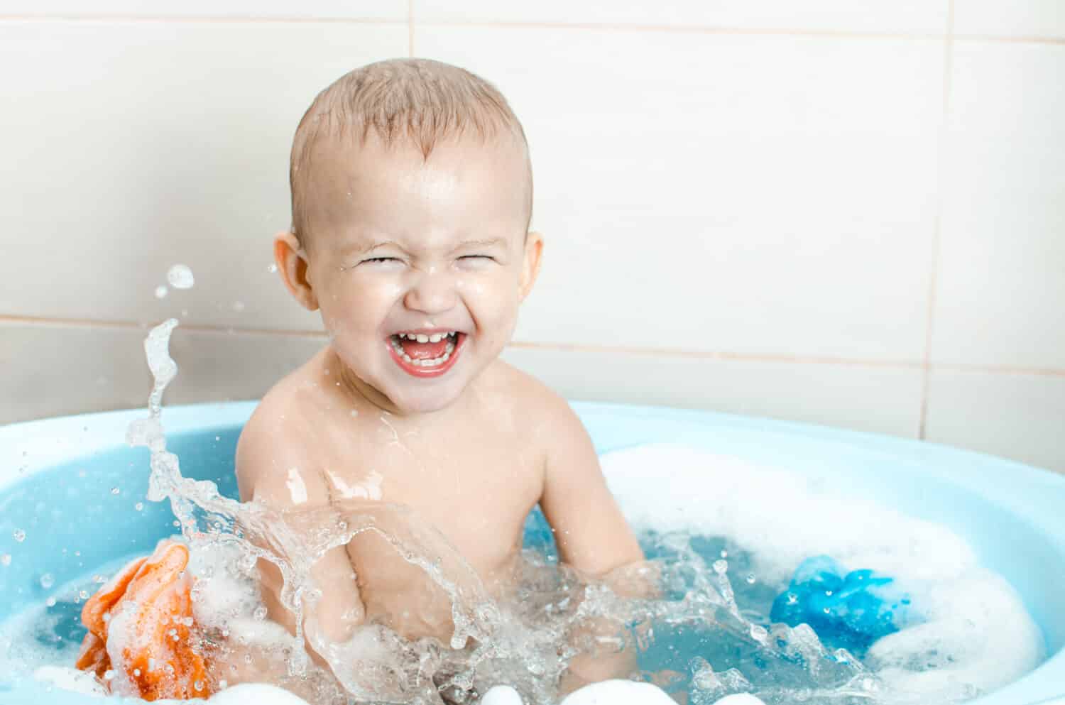 Handsome boy preschooler bathing in the bathroom clean and hygienic