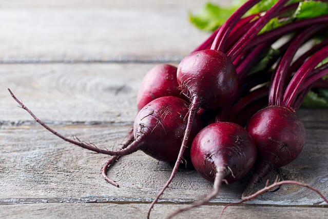 Fresh organic beet, beetroot. Grey rustic wooden background. Close up.