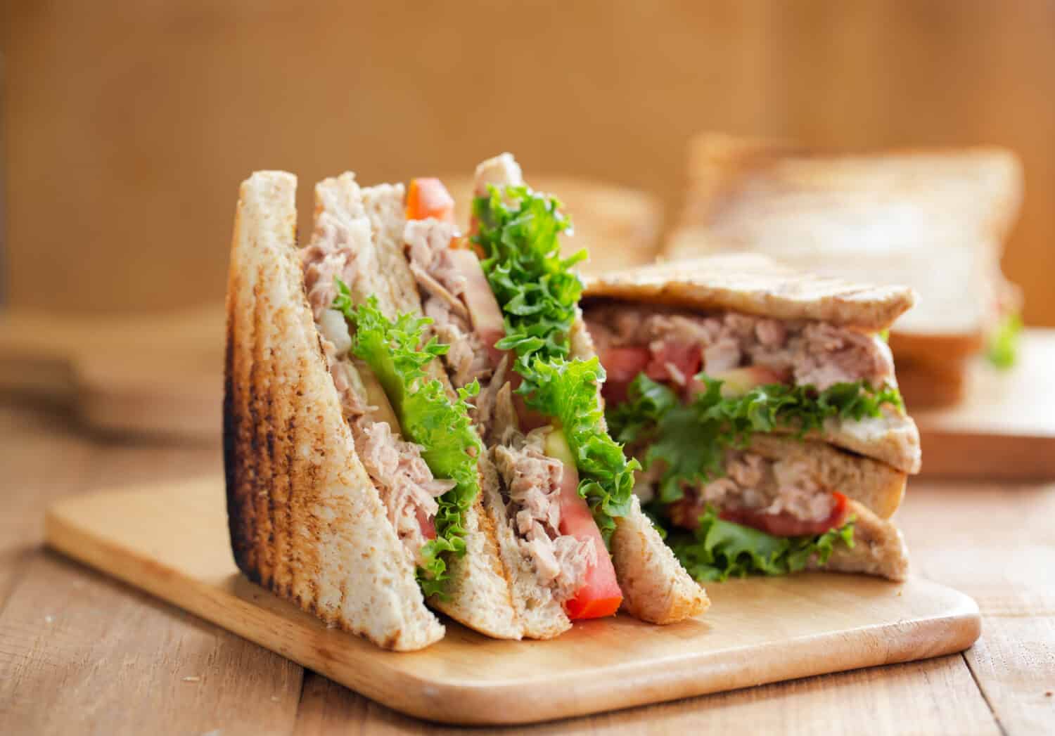 tuna sandwich on wooden board
