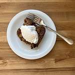 Slice of fresh apple dump cake with whipped cream