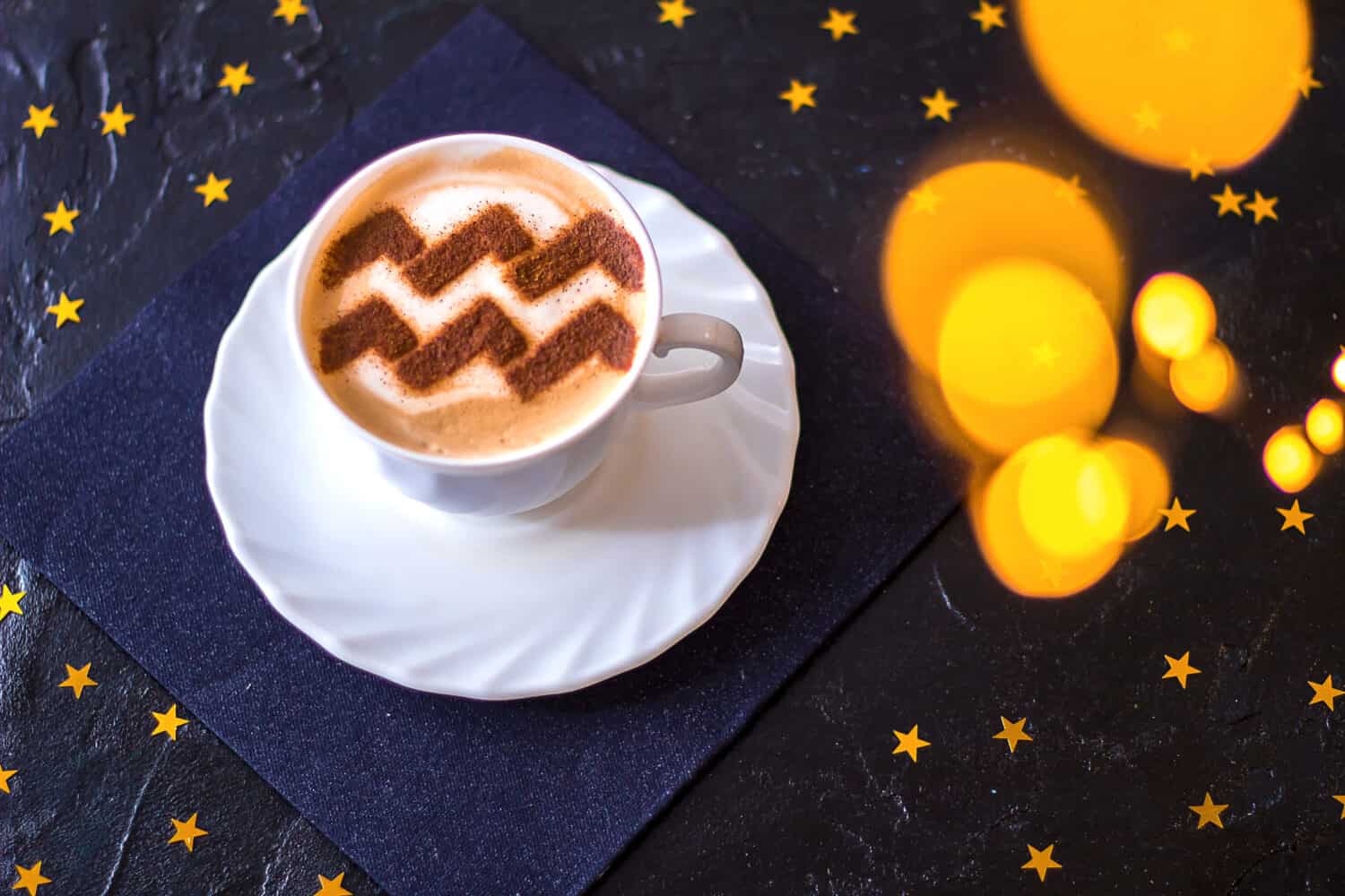 white cup of coffee with the symbol of the zodiac Aquarius on milk foam
