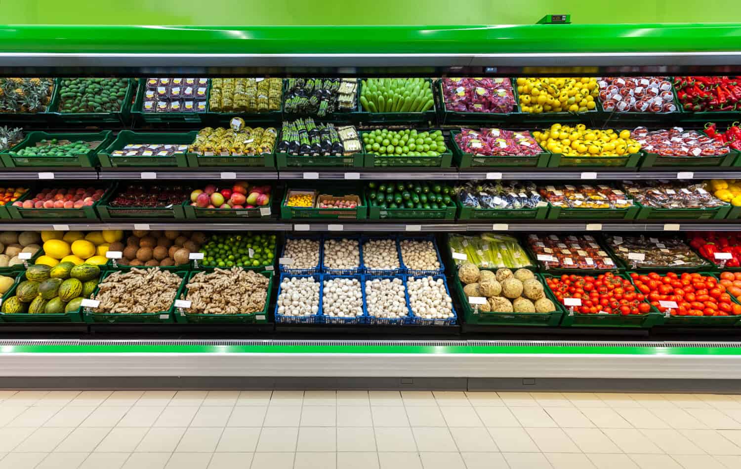 Fresh fruits and vegetables on the shelf in the supermarket  