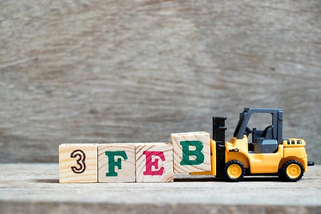 Toy forklift hold block B to complete word 3feb on wood background (Concept for calendar date 3 in month February)